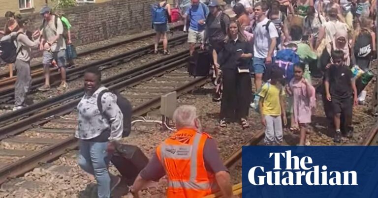 Evacuated London train passengers forced to walk along tracks on hottest day of year | Rail transport