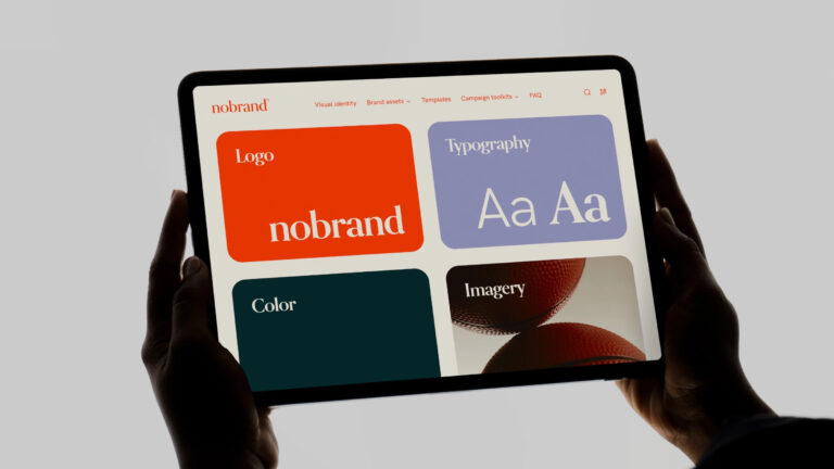 Frontify brand guidelines on an iPad held up by two hands
