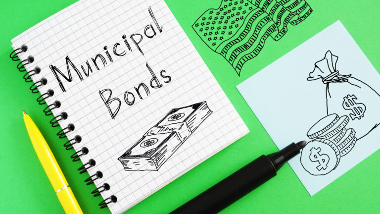 &quot;Municipal bonds&quot; is written in a notebook, with drawn pictures of cash and coins on a bright green background.