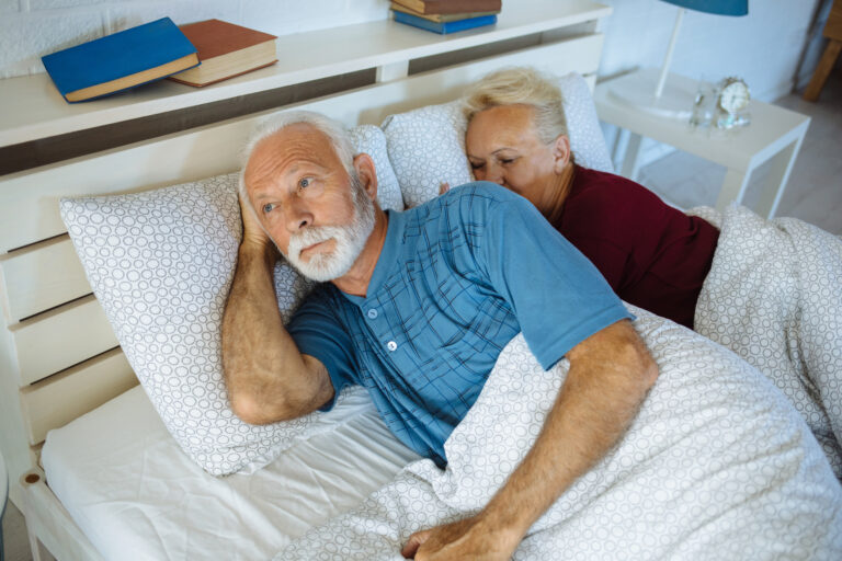 man in bed with his wife worried