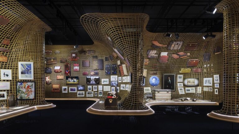 A display of Louis Vuitton artifacts on woven bamboo walls at the "Visionary Journeys" exhibition in Osaka.