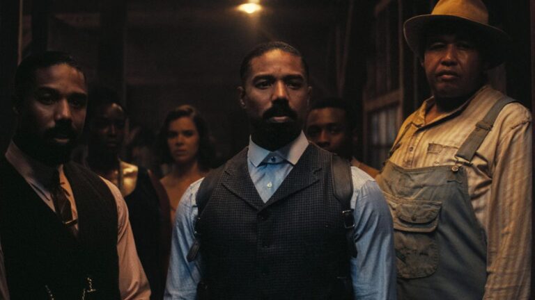 3 men stand in doorway