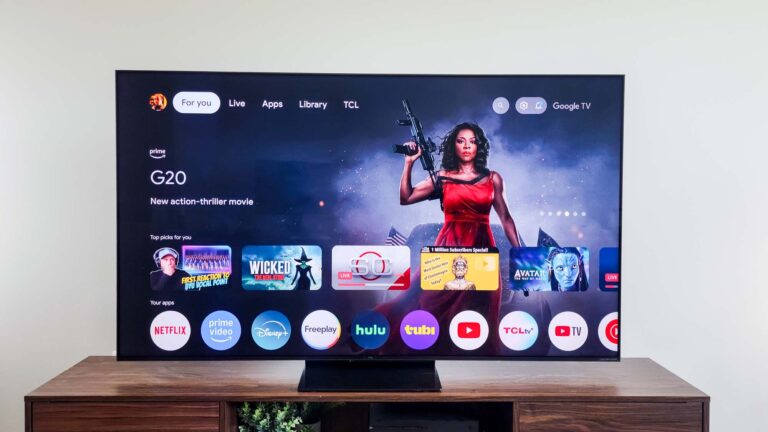 A TCL QM7K QD-Mini LED TV on a side table