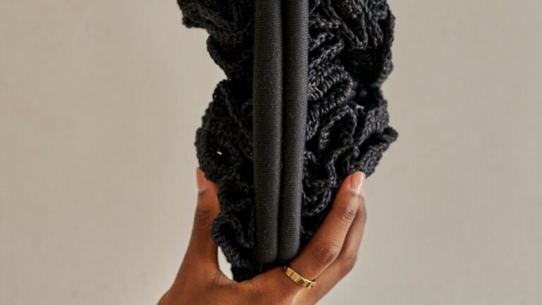 The crocheted rose clutch is handcrafted by Syrian refugee