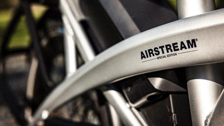Close-up of a metallic silver bicycle frame with the text