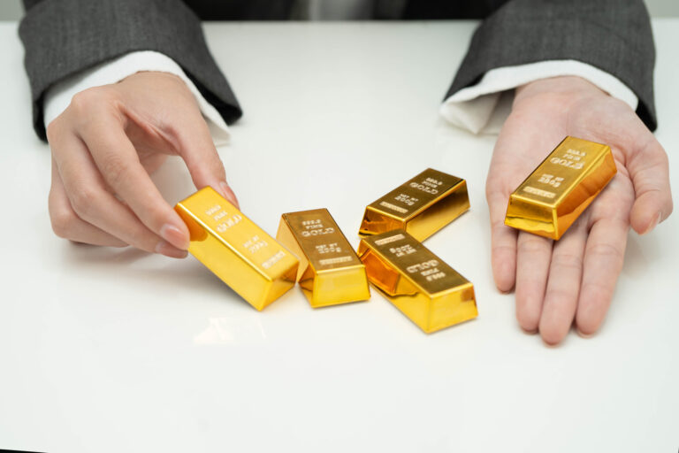 Buying Gold as an Investment: What to Watch For Hands presenting small gold bars