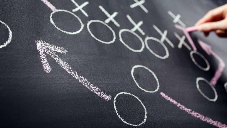 Playing Defense Pays Off for Our Favorite Junk Bond Fund person drawing football plays on chalkboard