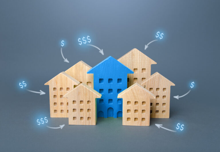 The Capital Gains Tax Squeeze Retirees Can’t Ignore: What’s Next? group of wooden houses with dollar signs above them