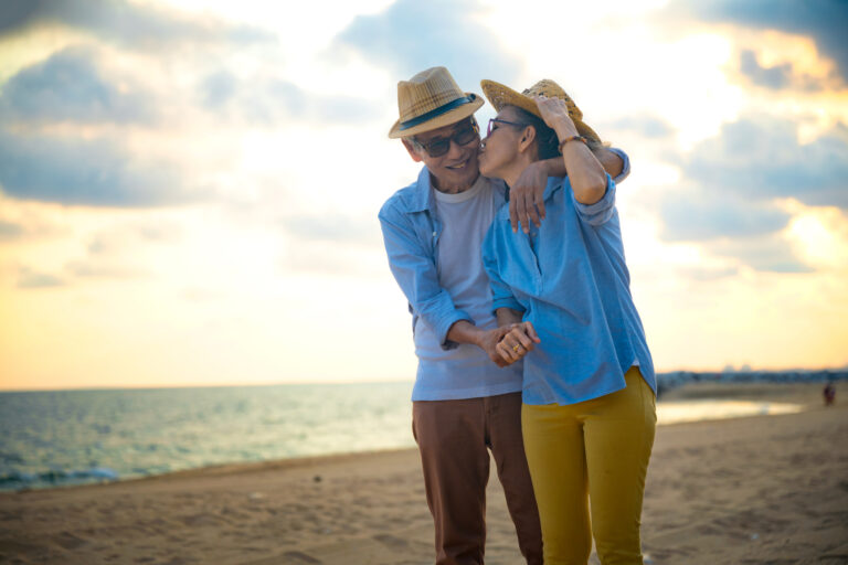 Three Out-Of-The-Box Retirement Moves the Wealthy Swear by Happy couple on the beach