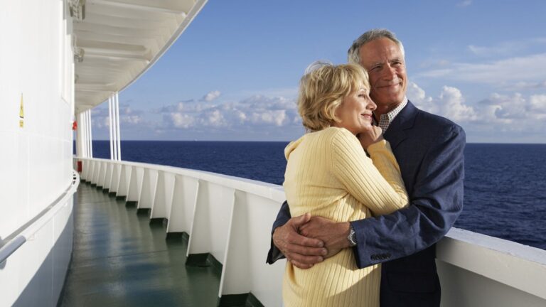 The Ultimate Cruise Packing List for Retirees A mature couple hugging on a cruise ship.