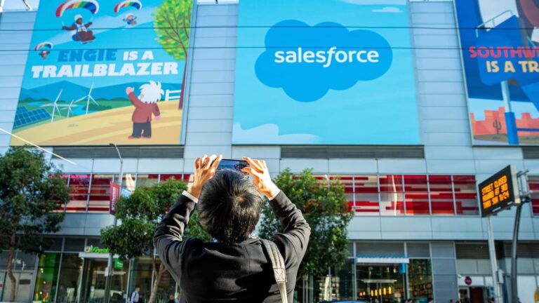 What Does Salesforce Do? | Salesforce Man snaps photo of Salesforce logo: What does Salesforce do