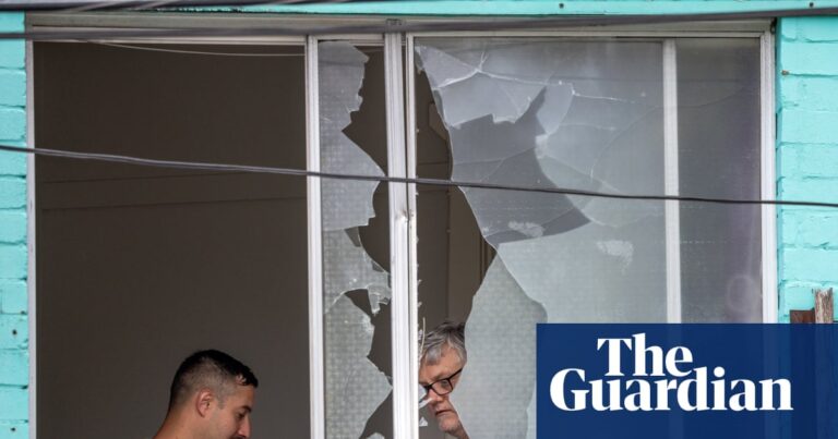 ‘Non-stop bang bang bang’: man arrested after about 50 shots fired from Sydney flat into street, injuring 16 | Sydney